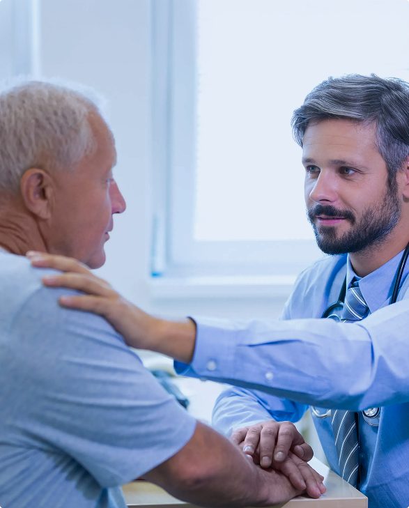 Doctor reassuring an elderly patient with a comforting hand on the shoulder